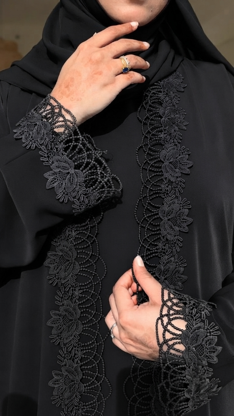 This Black beauty is a 3-piece set—an inner dress, a delicate lace abaya layer, and a matching shela/hijab