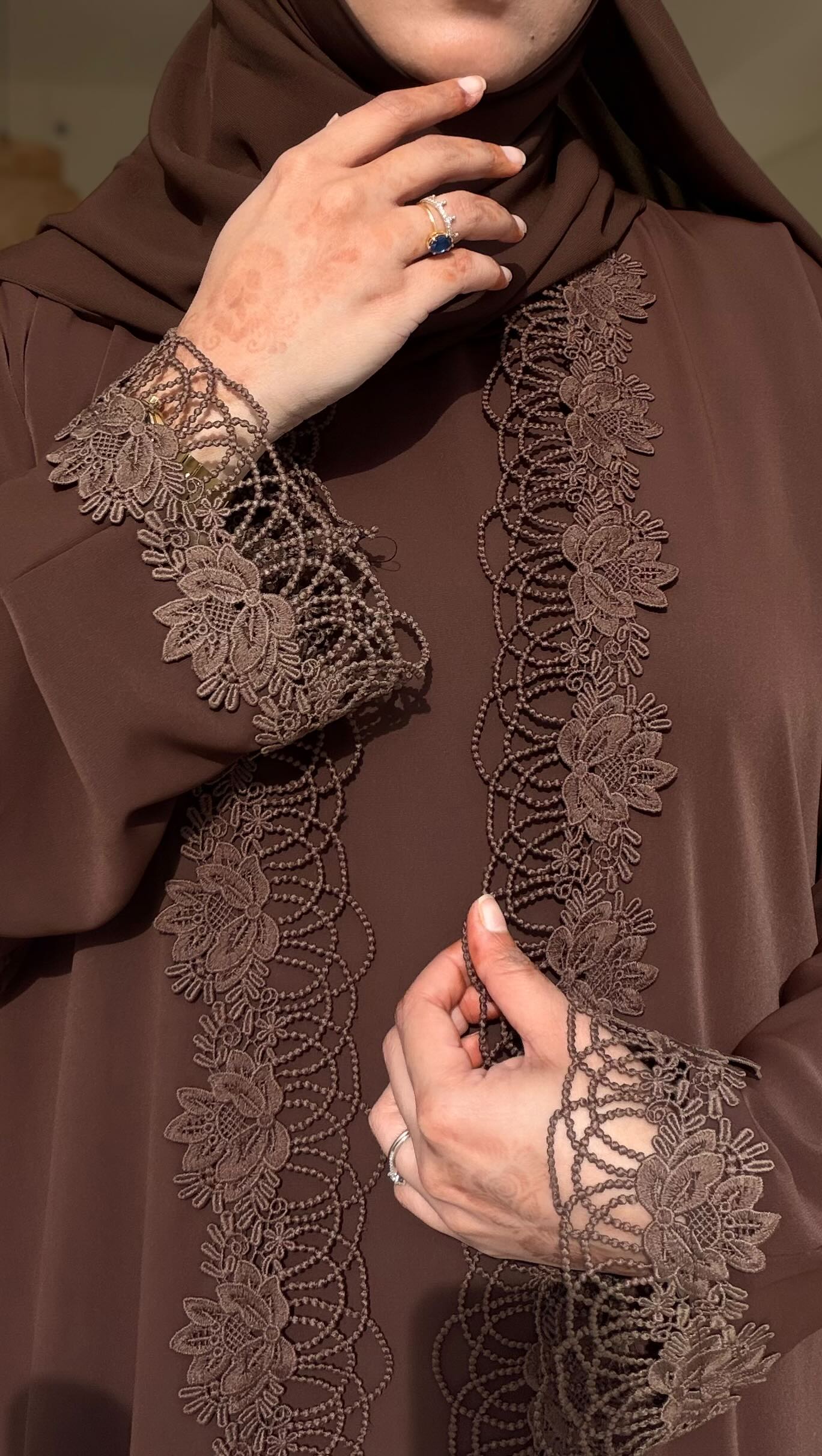 This Brown beauty is a 3-piece set—an inner dress, a delicate lace abaya layer, and a matching shela/hijab
